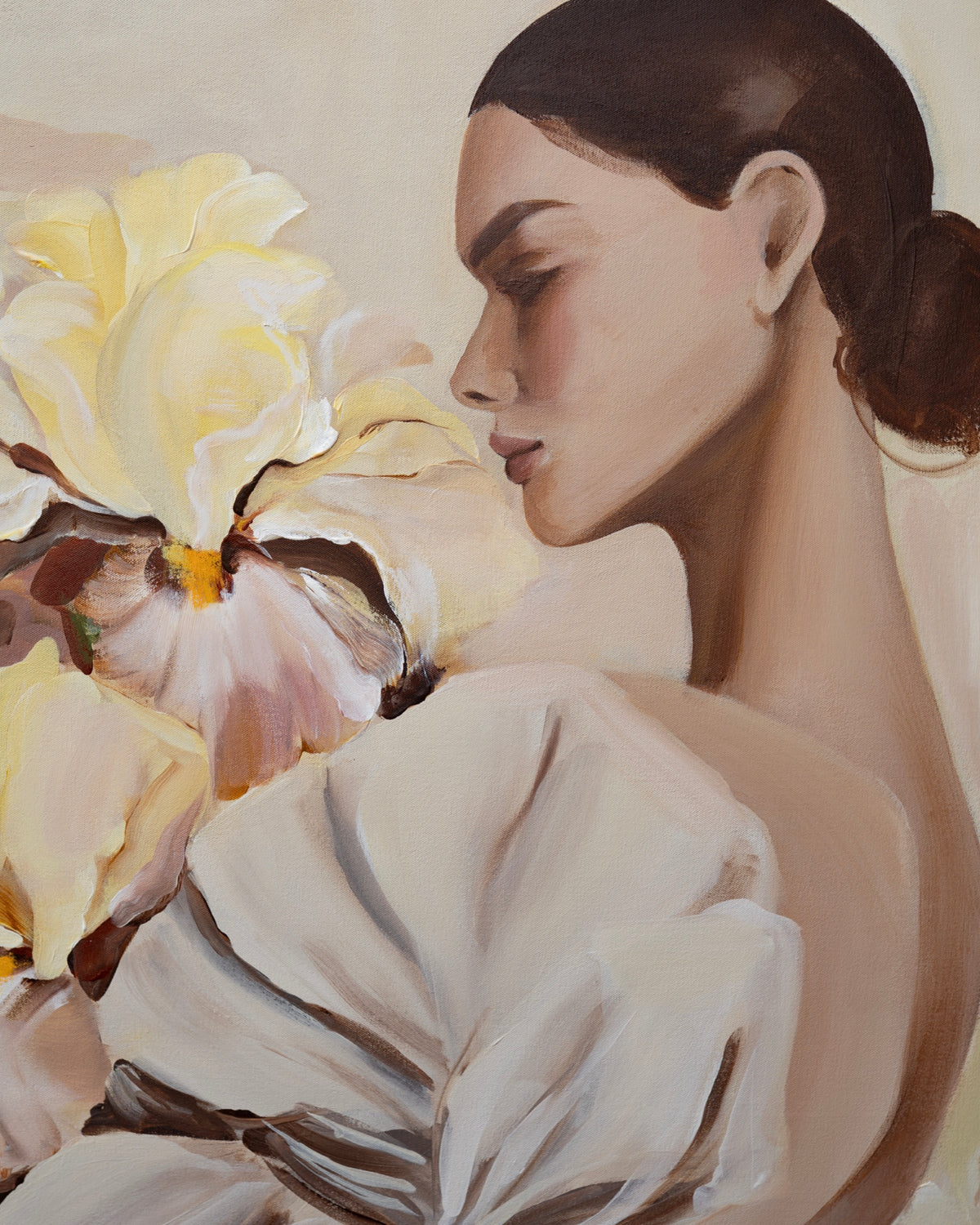 Detail of Grace by Janka Kykalová, showing the woman's profile, dark hair in a bun and cream dress beside yellow and mauve irises.
